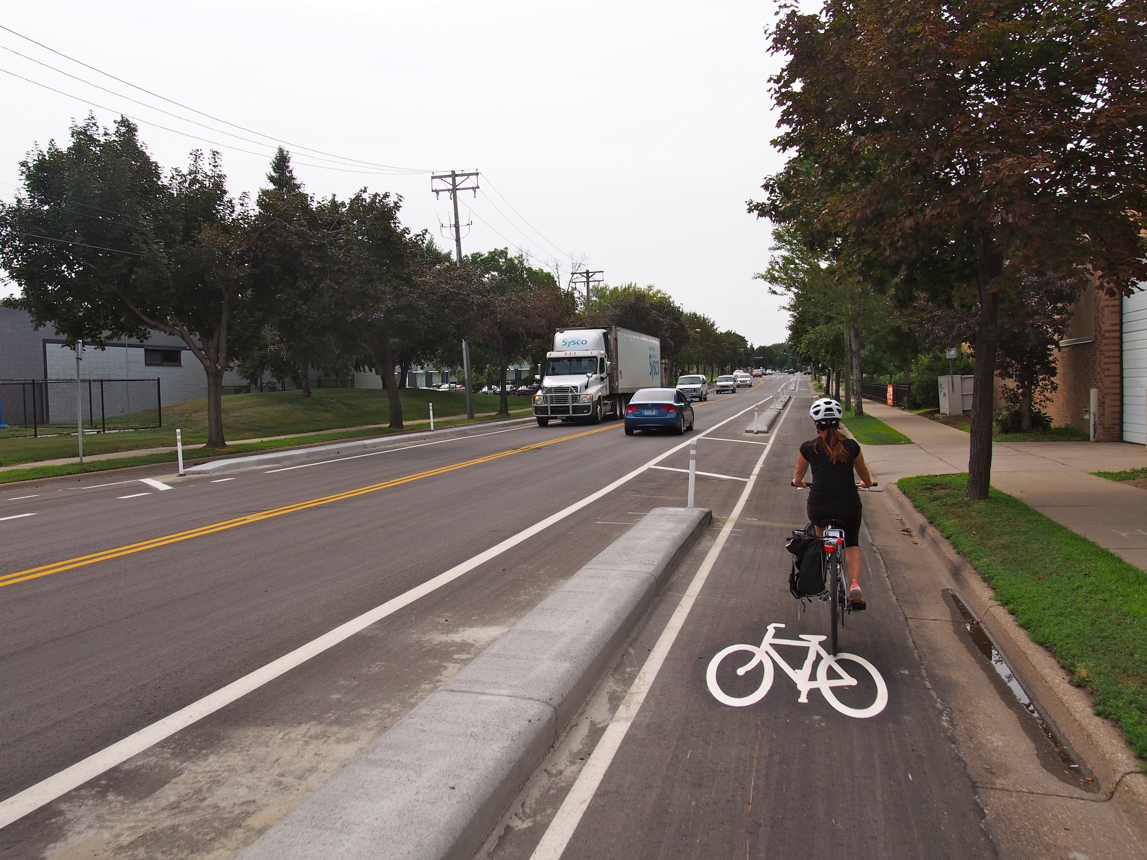 Curb separated bike lane presents temporary parking in lane